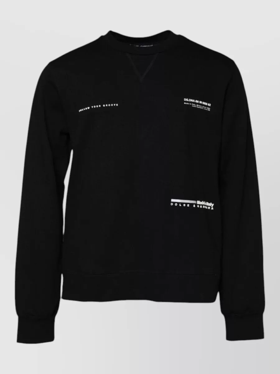 Dolce&Gabbana Cotton logo-print sweatshirt — The clean black sweatshirt with subtle white micro text keeps the focus on the bomber’s dramatic monochrome print while matching its palette and street-tailored mood.
