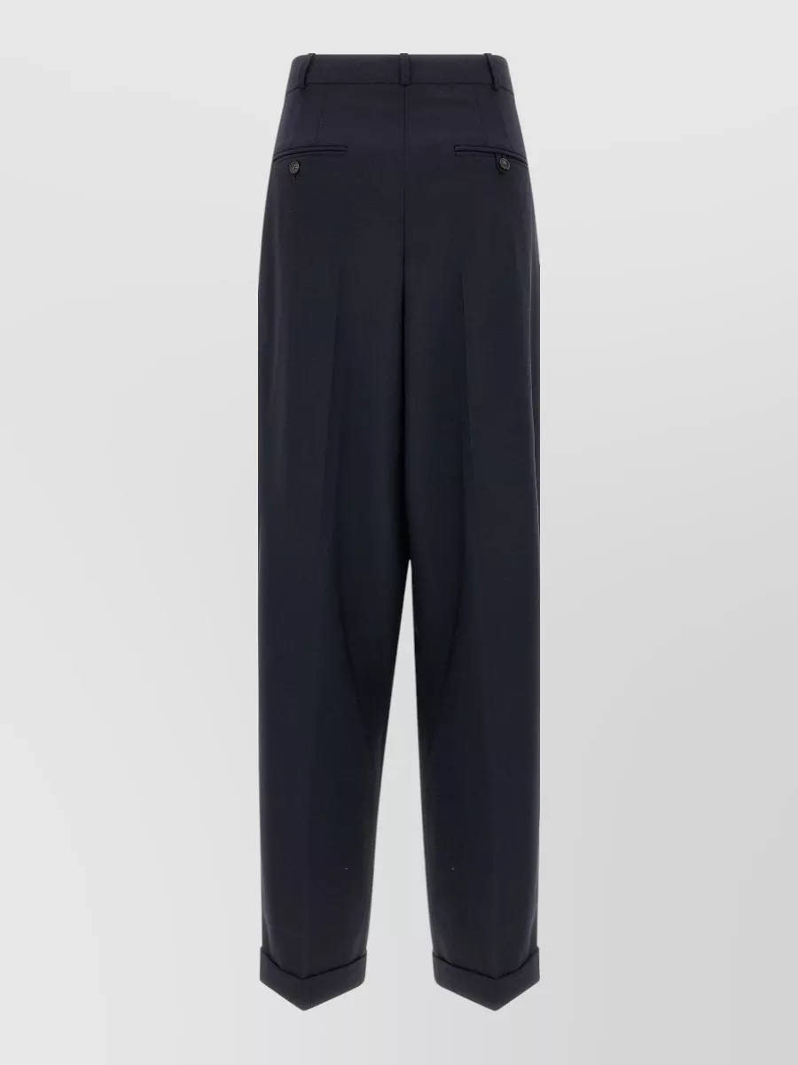 Polo Ralph Lauren Wool mid-rise wide-leg tailored trousers — The high-rise navy pleated trouser matches the cardigan’s quiet-luxury, preppy mood and formality, giving a clean menswear-inspired line that balances the cropped bomber shape.