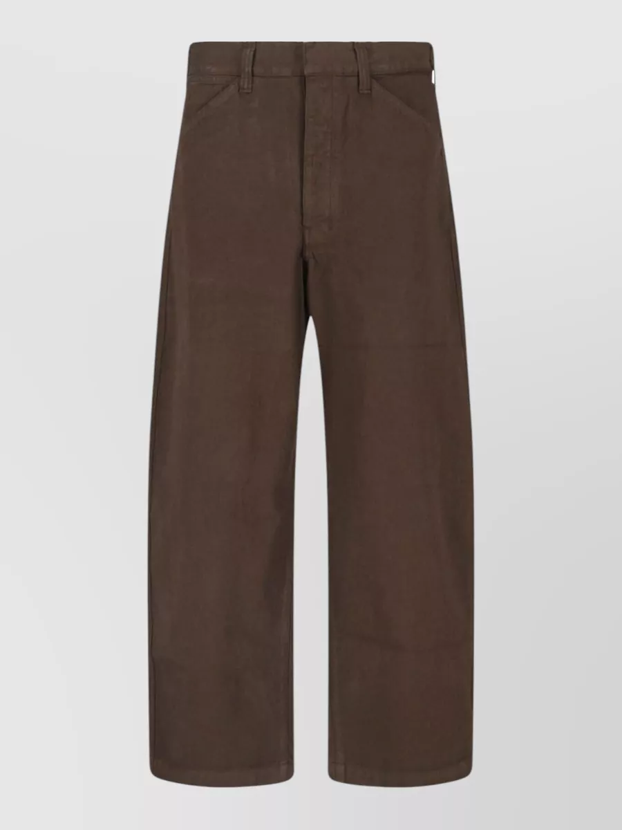 Lemaire Straight-leg trousers — The Lemaire straight-leg trouser in deep chocolate closely matches the tee’s tone for a rich monochrome column, keeping the silhouette clean and relaxed while staying within a quiet luxury universe.