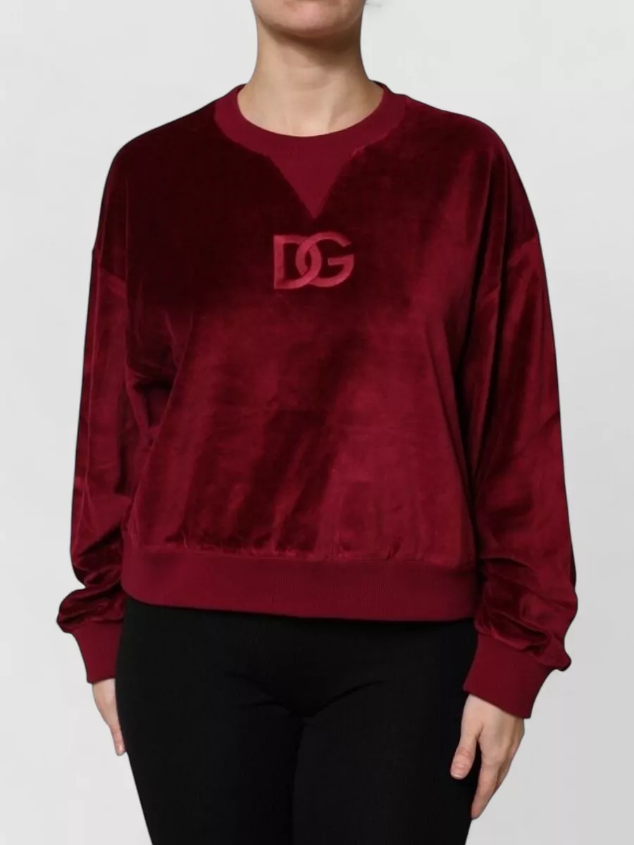 Dolce&Gabbana Velvet crew neck sweatshirt — The deep burgundy sleeveless knit quietly grounds the shorts’ intense print while matching their rich tones, keeping the silhouette clean and the mood street-sport with a hint of polish.