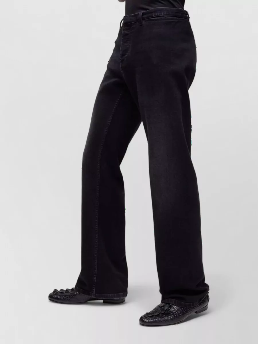 Gucci Denim low-rise flared jeans — The regular straight-leg black denim delivers a sharp but relaxed line that grounds the sporty leather bomber without competing with its statement stripe.