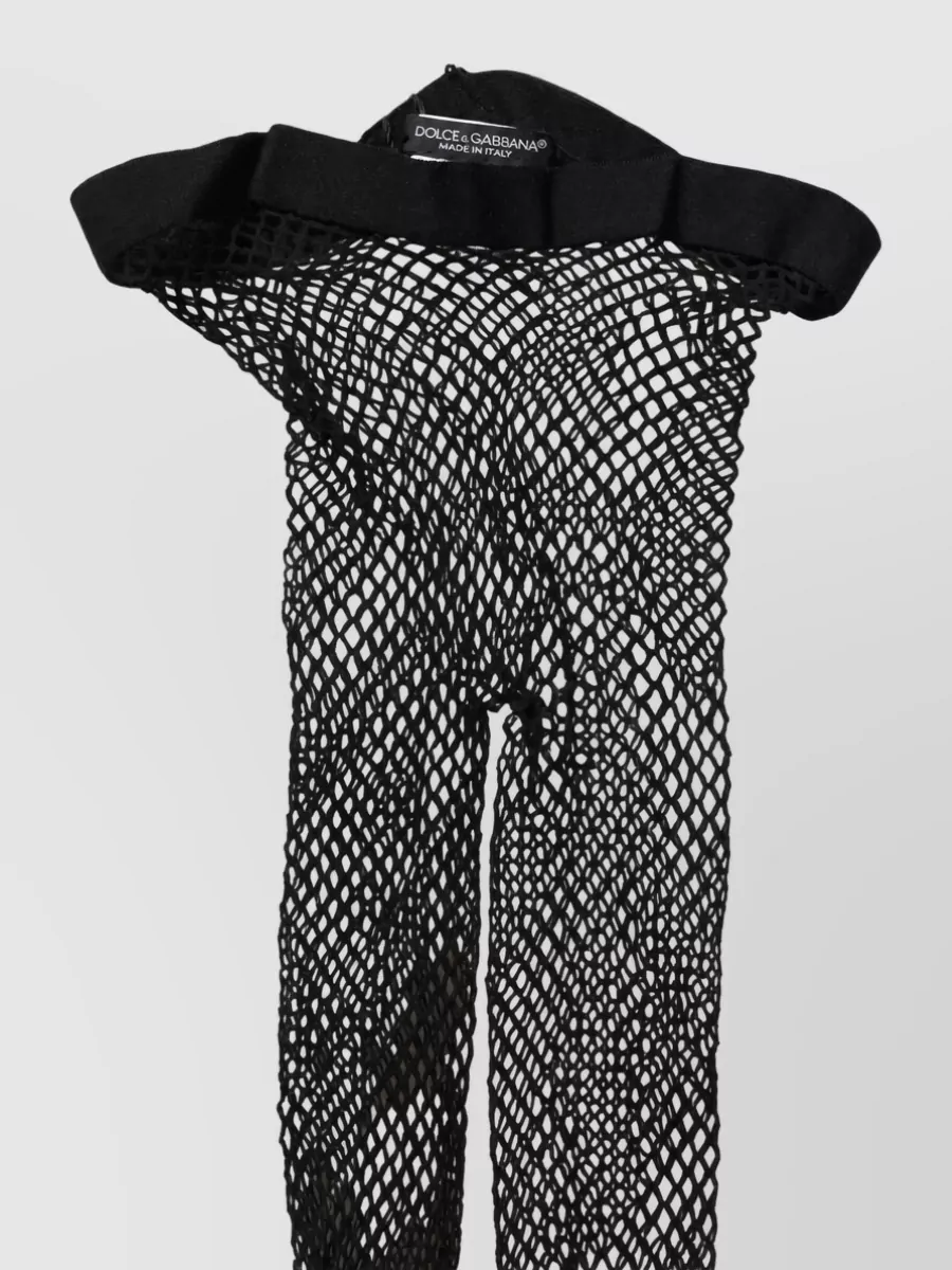Dolce&Gabbana Fishnet tights — The Dolce&Gabbana fishnet tights tie into the top’s sheer mesh sleeves, adding texture and leg coverage that keeps the mini balanced and very night-out.