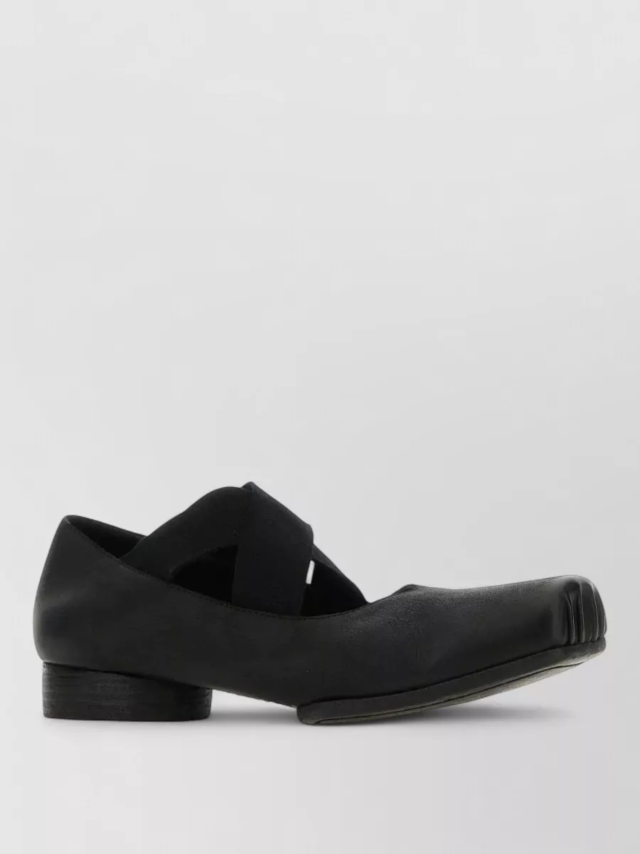 Uma Wang Leather ballerina flats — The low block-heel square-toe ballerina in matte black is sculptural yet quiet, matching the coat’s artisanal tailoring while keeping the silhouette grounded and walkable.