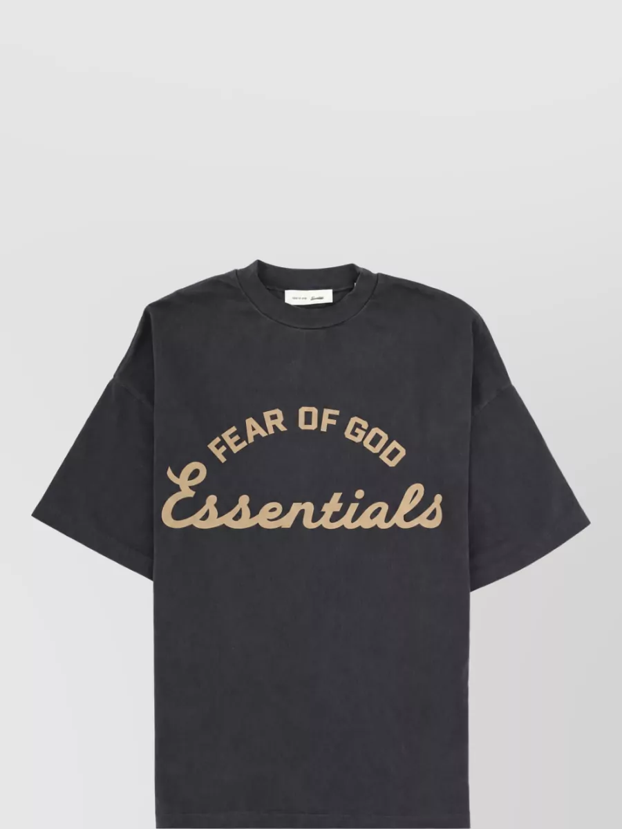 Fear Of God Cotton short-sleeve shirt — The washed charcoal Essentials tee mirrors the pant’s black base and tan logo, keeping a tight Fear Of God story and relaxed street uniform in a low-contrast palette.