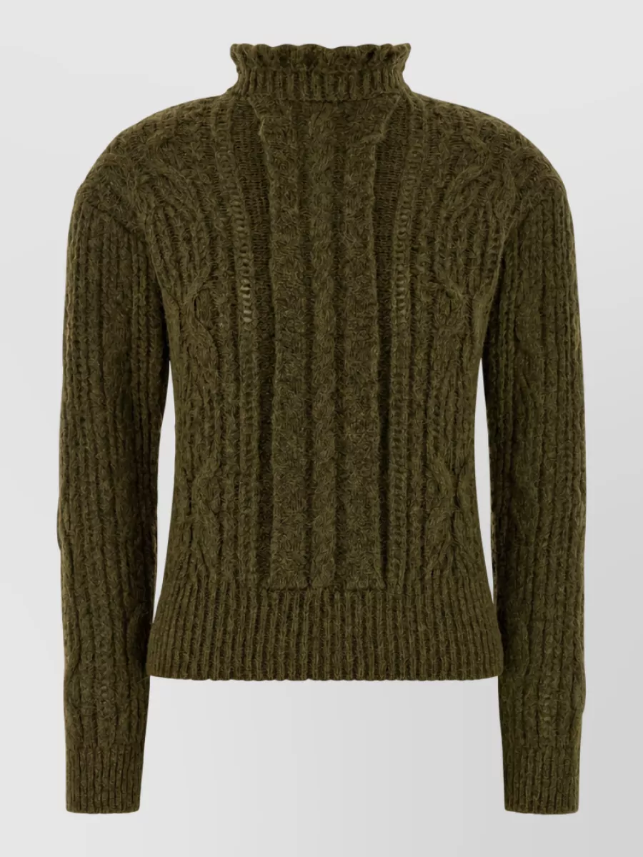 Moncler Grenoble Alpaca-blend jumper — The olive cable-knit turtleneck echoes the parka’s tone and alpine-sport mood, creating a tonal, quiet-luxury column under the coat without adding bulk.