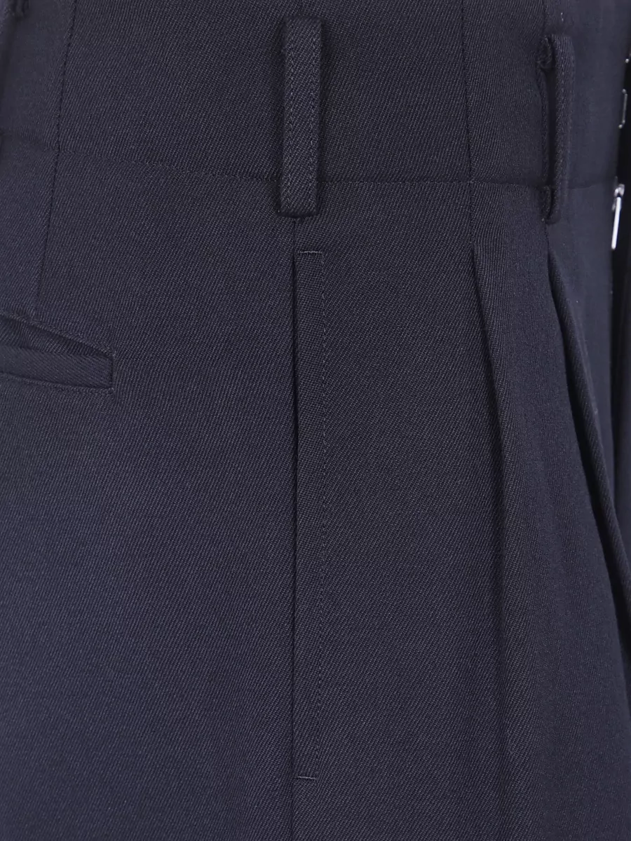 Comme des Garçons Wool wide-leg trousers — The deep navy high waisted wide leg trouser gives a quiet, tailored counterpoint to the ruched white blouse, keeping the outfit minimalist, polished and gallery-to-dinner appropriate.