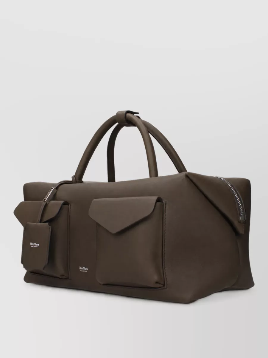Max Mara Leather tote bag — The Max Mara dark chocolate shoulder tote feels quietly structured, sits well with the coat’s polish, and repeats the deep brown from the footwear in a softer way.