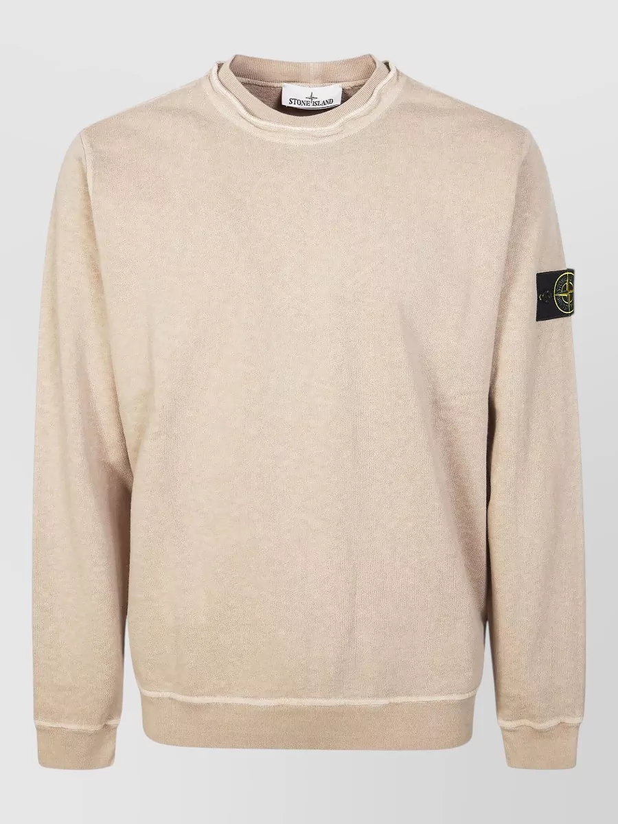 Stone Island Cotton ribbed crewneck sweatshirt — The sand crewneck keeps the palette almost tonal with the outerwear for a very clean, minimalist utility story while avoiding bulky double-hood layering.
