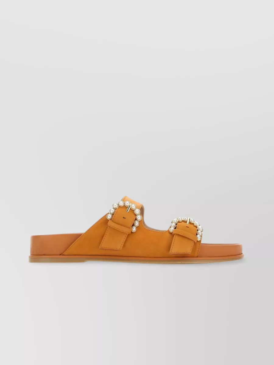 Shop Stuart Weitzman Piper Suede Slippers With Jewel Buckle And Pearl Embellishments In Orange