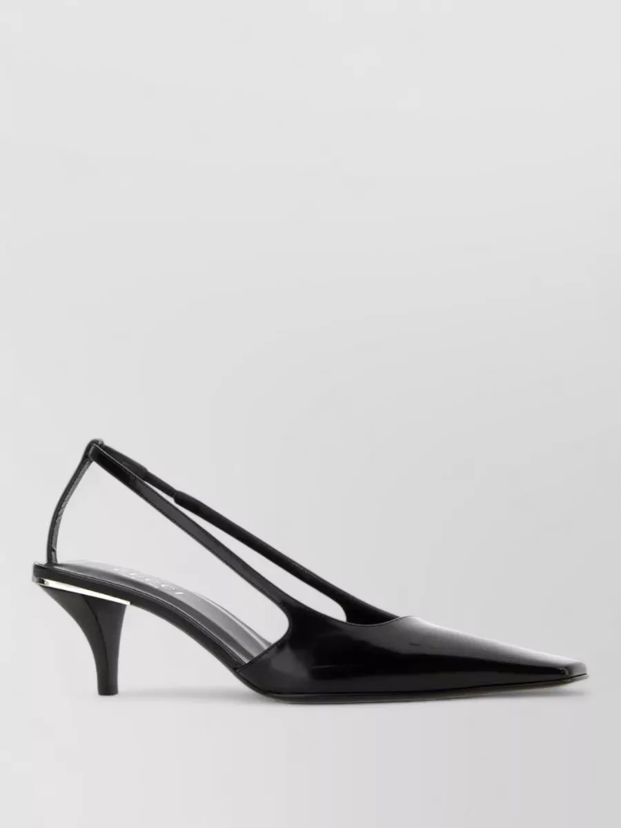 Gucci Leather pumps — The ivory block-heel sandal keeps the palette tonal, matches the dress’s refined day-event formality, and adds a discreet touch of gold hardware without competing with the dress’s logo buttons.