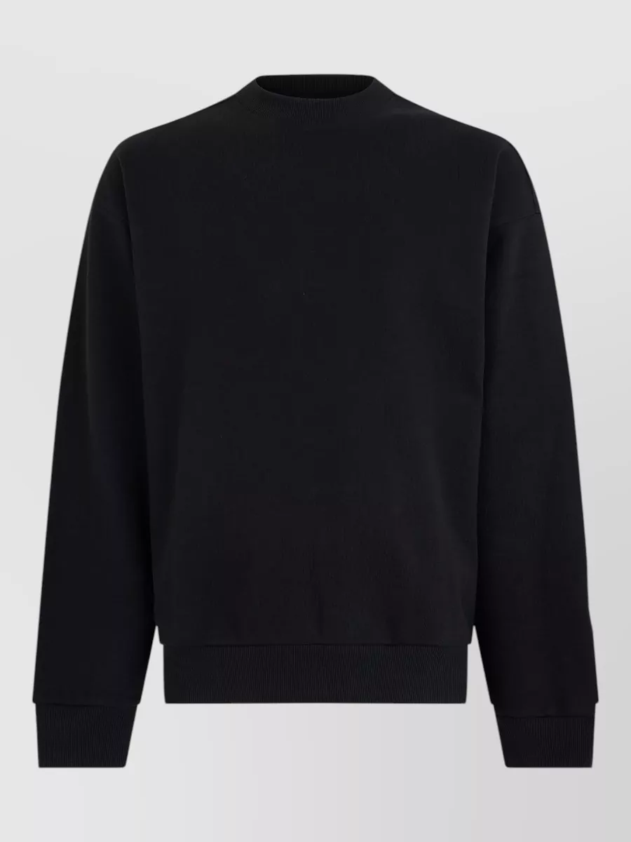 Boss Cotton crew-neck sweatshirt — The pure black minimalist crew sweatshirt aligns perfectly with the padded black bomber for a clean, tonal street-sport mood without competing zips or hood bulk under the collar.