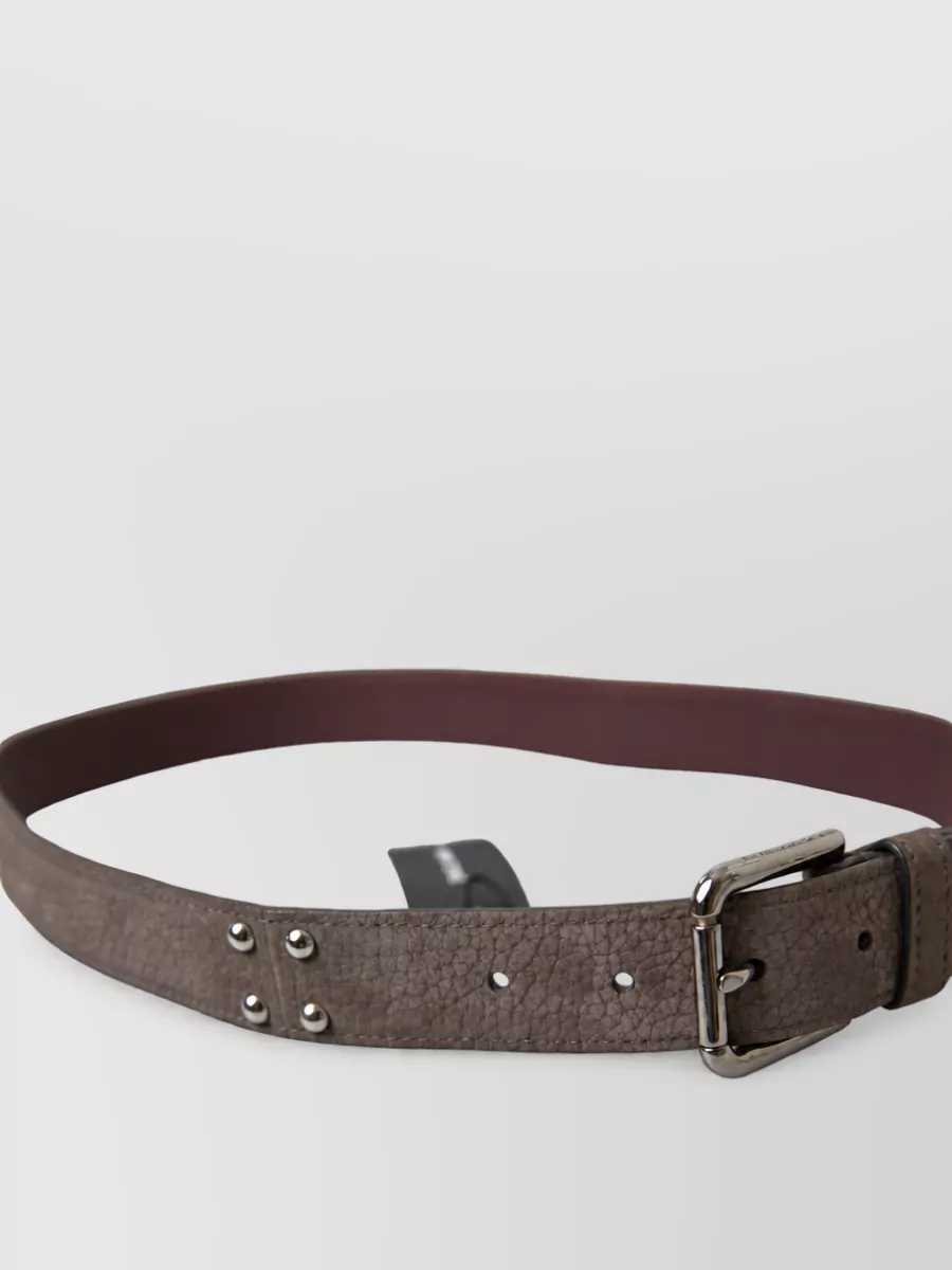 Dolce&Gabbana Leather belt — The slim taupe belt quietly frames the high waist of the trouser, adding structure and a subtle color bridge between the soft blue shirt and green-toned bag.