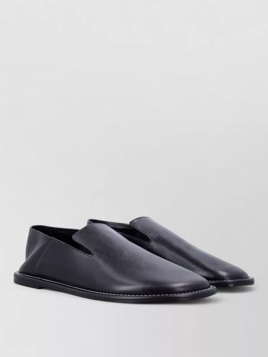 Ami Paris Leather loafers — The minimal black Ami Paris slip-ons mirror the belt’s black leather and silver hardware, keeping the silhouette sleek without adding visual noise.