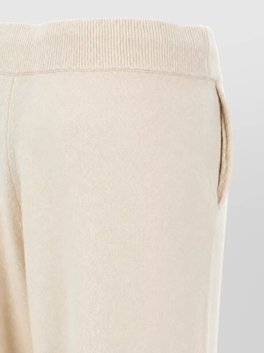 Yves Salomon Cashmere wool ribbed cuff sweatpants — The Yves Salomon oatmeal knit joggers echo the slipper’s loungewear spirit and palette, creating a tonal, cocooning set that feels refined enough for off-duty city errands.
