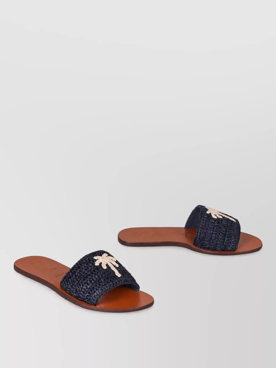 Manebi raffia leather flat slides