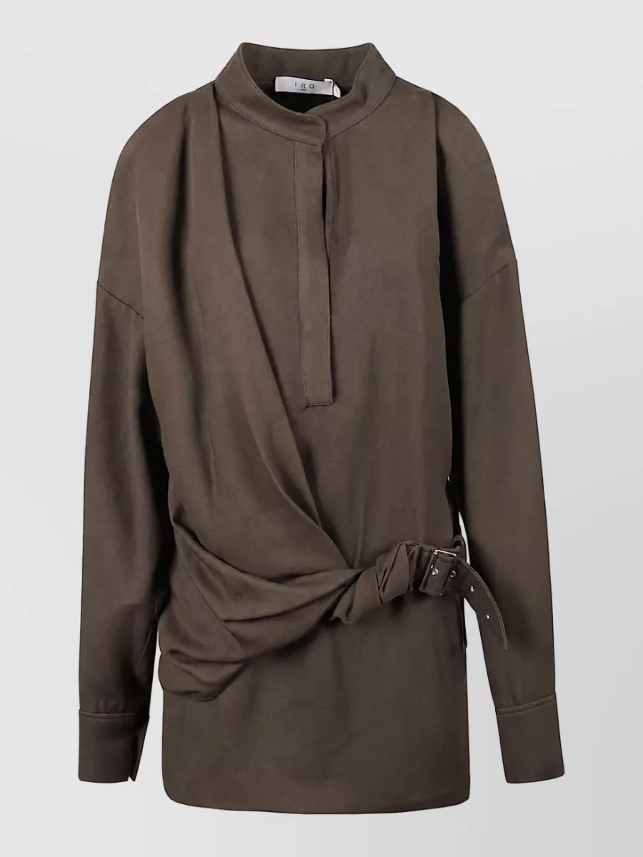 Iro Blouse — The belted longline Iro blouse mirrors the trouser’s minimalist, chocolate palette and adds a defined waist to balance the wide leg while keeping the ensemble in the same quiet-luxury, mid-formality register.