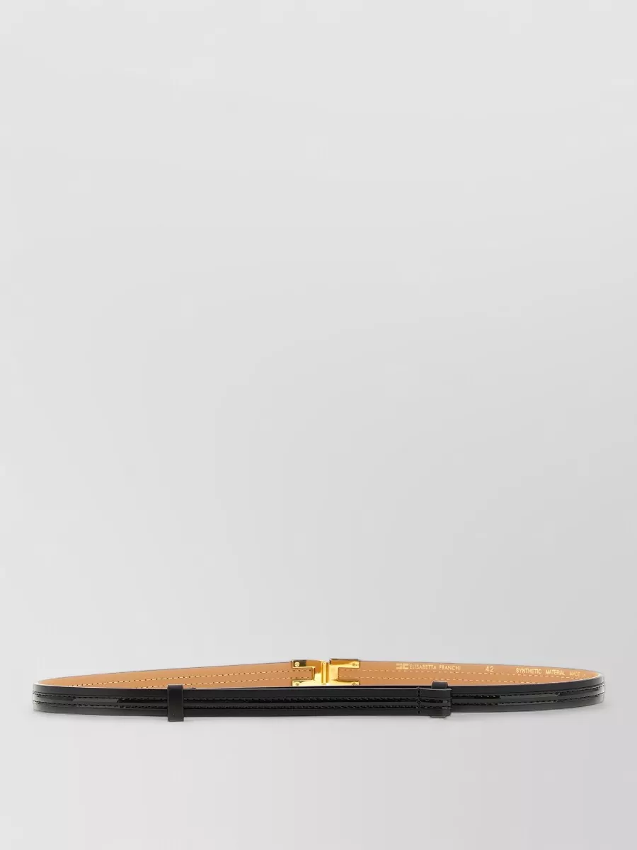 Elisabetta Franchi Leather logo buckle belt — The slim black Elisabetta Franchi belt quietly defines the high waist without breaking the navy column, adding subtle polish that echoes the bag and shoe hardware.