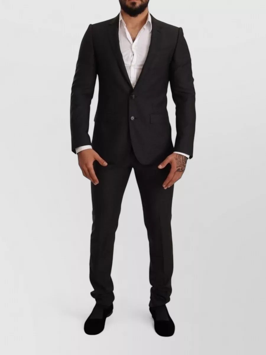 Dolce&Gabbana Wool slim-fit tailored trousers — The slim black tailored trouser in F mirrors the shirt’s sharp Italian line and keeps the monochrome, evening-ready mood focused without competing polka dots.