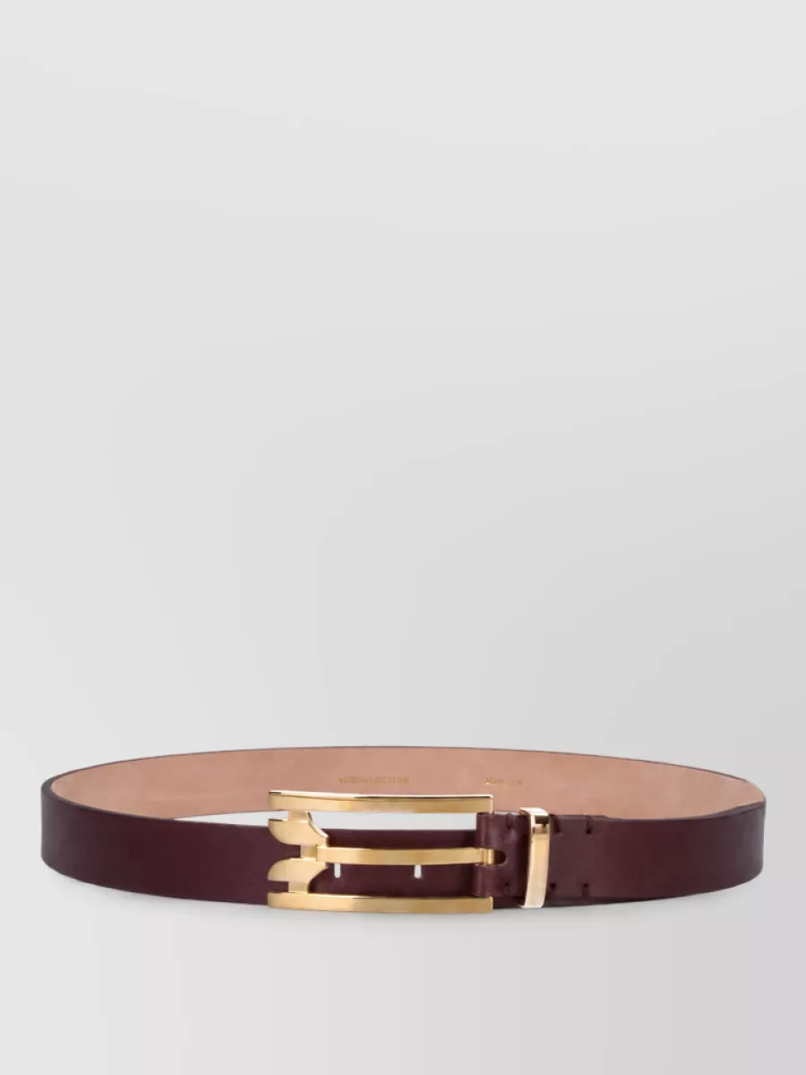 Victoria Beckham Leather belt — The slim Victoria Beckham burgundy belt can quietly define the waist over the fluid velvet without breaking the tonal story, adding just a refined line of color and gold hardware.