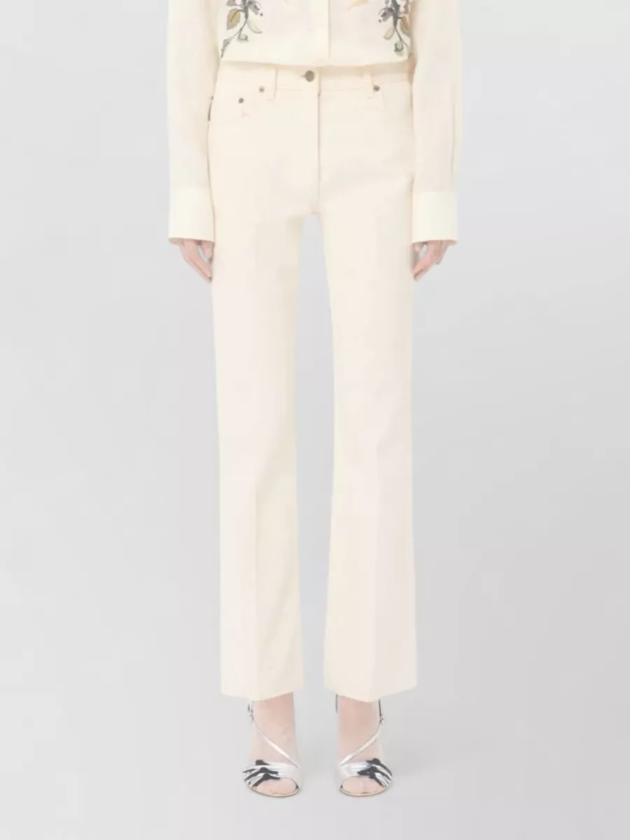 Valentino Garavani Flared Denim Trousers Featuring Pockets And Loops