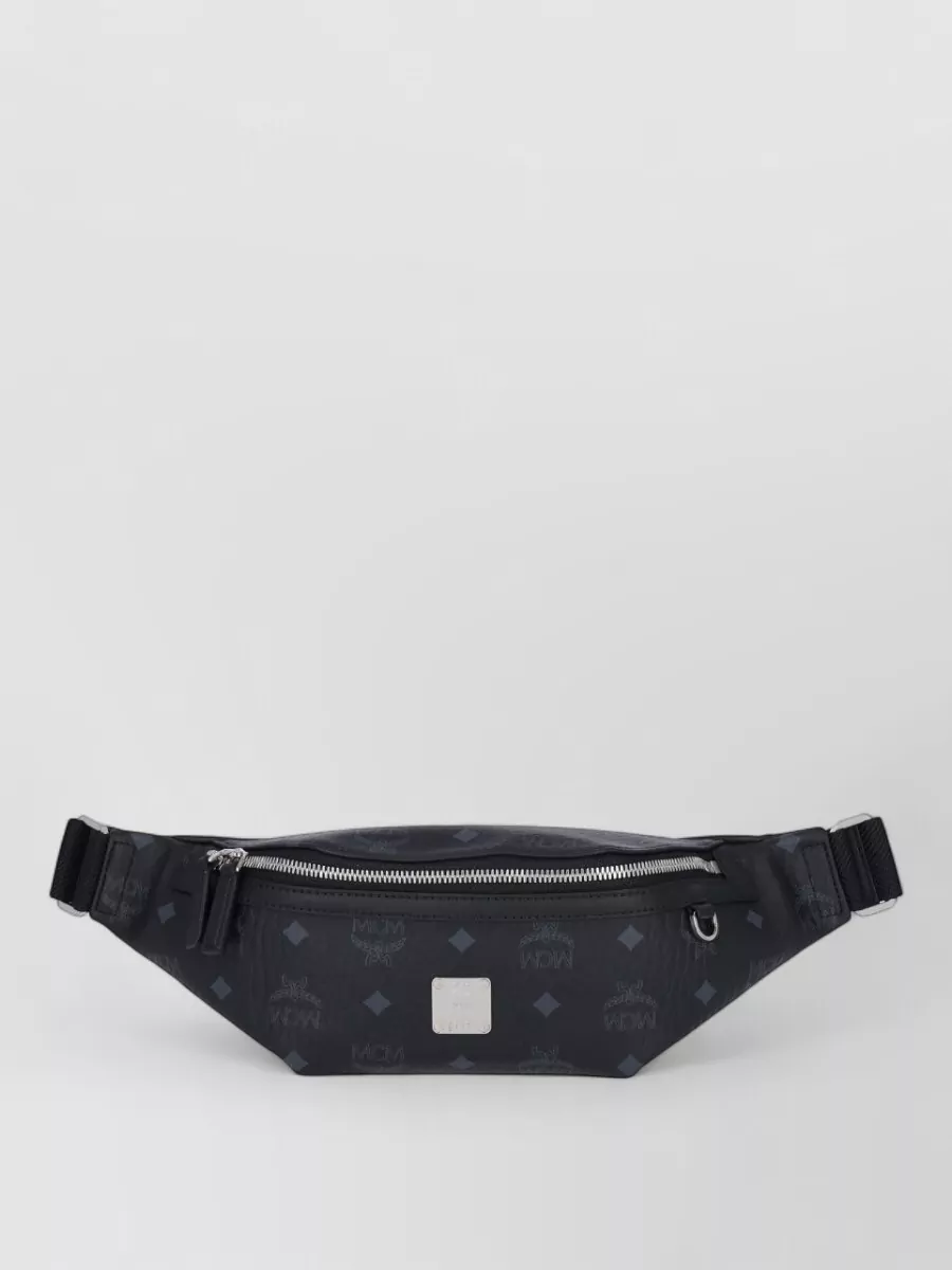 Mcm Belt bag — The black MCM belt bag reinforces the streetwear angle, keeps hands free, and sits neatly over the tee’s logo area without adding bulk to the wide-leg silhouette.