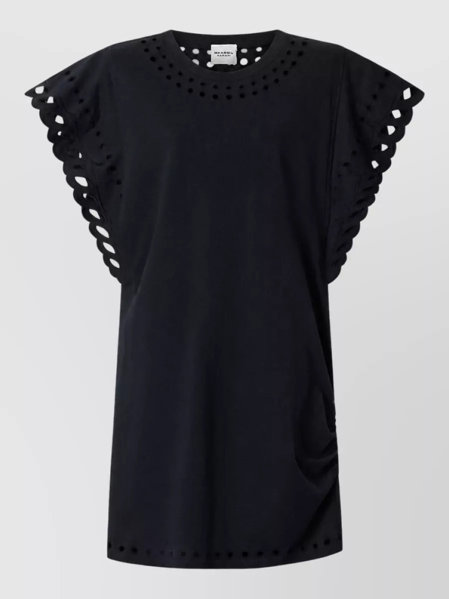 Isabel Marant Cotton mini dress — The black cut-out mini keeps the palette tight with the studded black vest and reads casual-daytime boho, so the two black pieces layer cleanly without competing silhouettes.