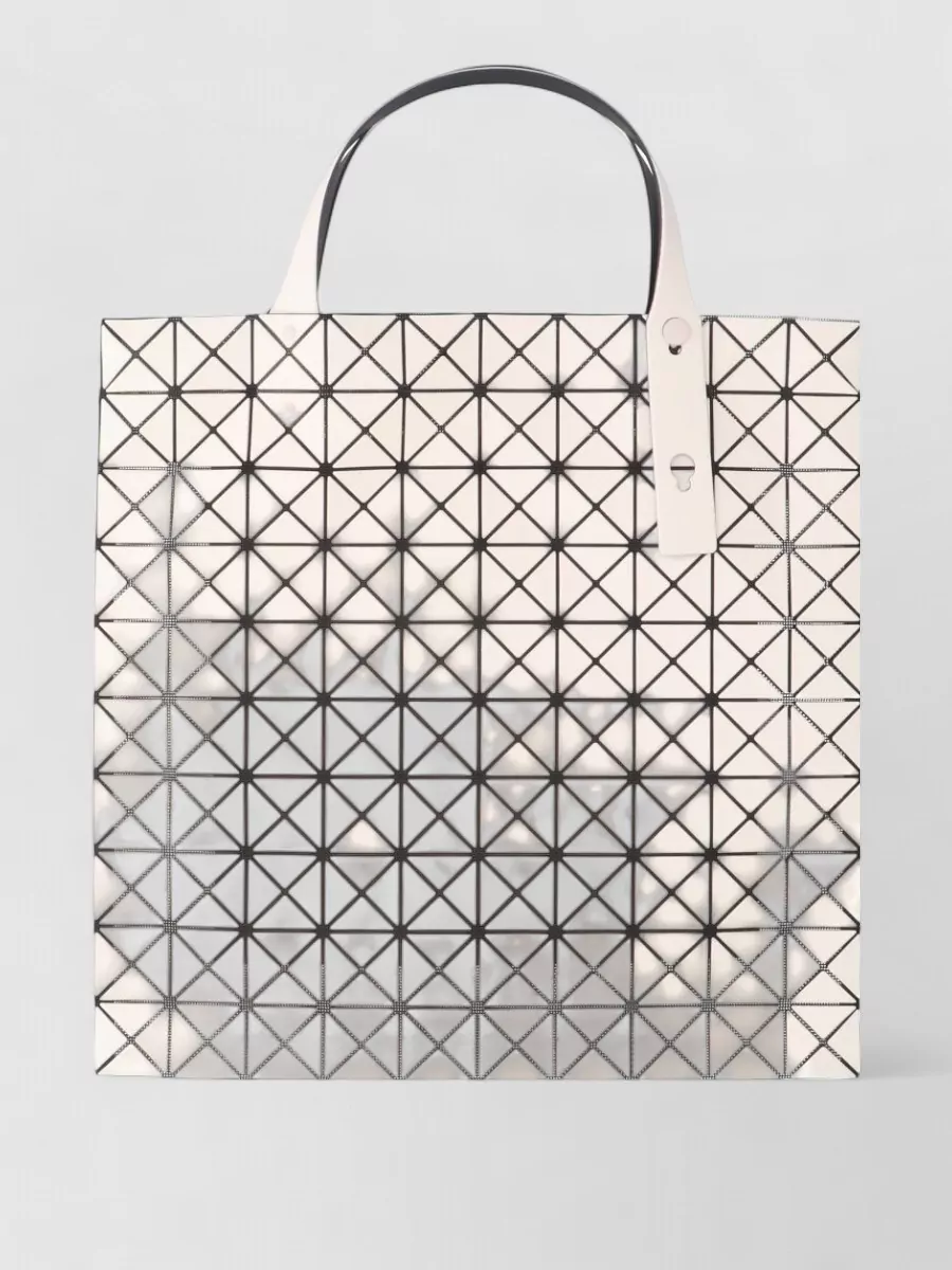 Bao Bao Issey Miyake Prism frost tote bag — The ivory Bao Bao tote mirrors the dress’s clean white base while its geometric texture adds a futuristic, sport-lux edge that feels right beside the Salomon tech aesthetic.