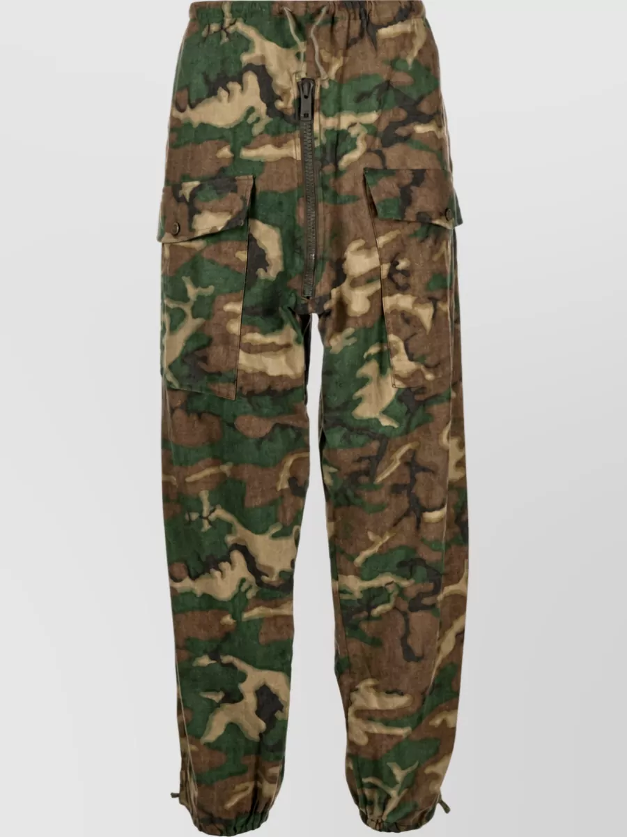 Givenchy Camouflage cotton loose fit trousers — The Givenchy camo jogger echoes the hoodie’s street-utility mood and camouflage story while keeping the palette in earthy greens that harmonise with the black base rather than competing with it.