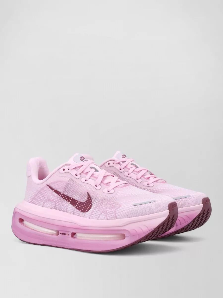 Nike Low-top sneakers — The pink cushioned runners sit in the same berry family as the bra and leggings, tying the palette together while keeping the vibe athletic and premium for training or city wear.