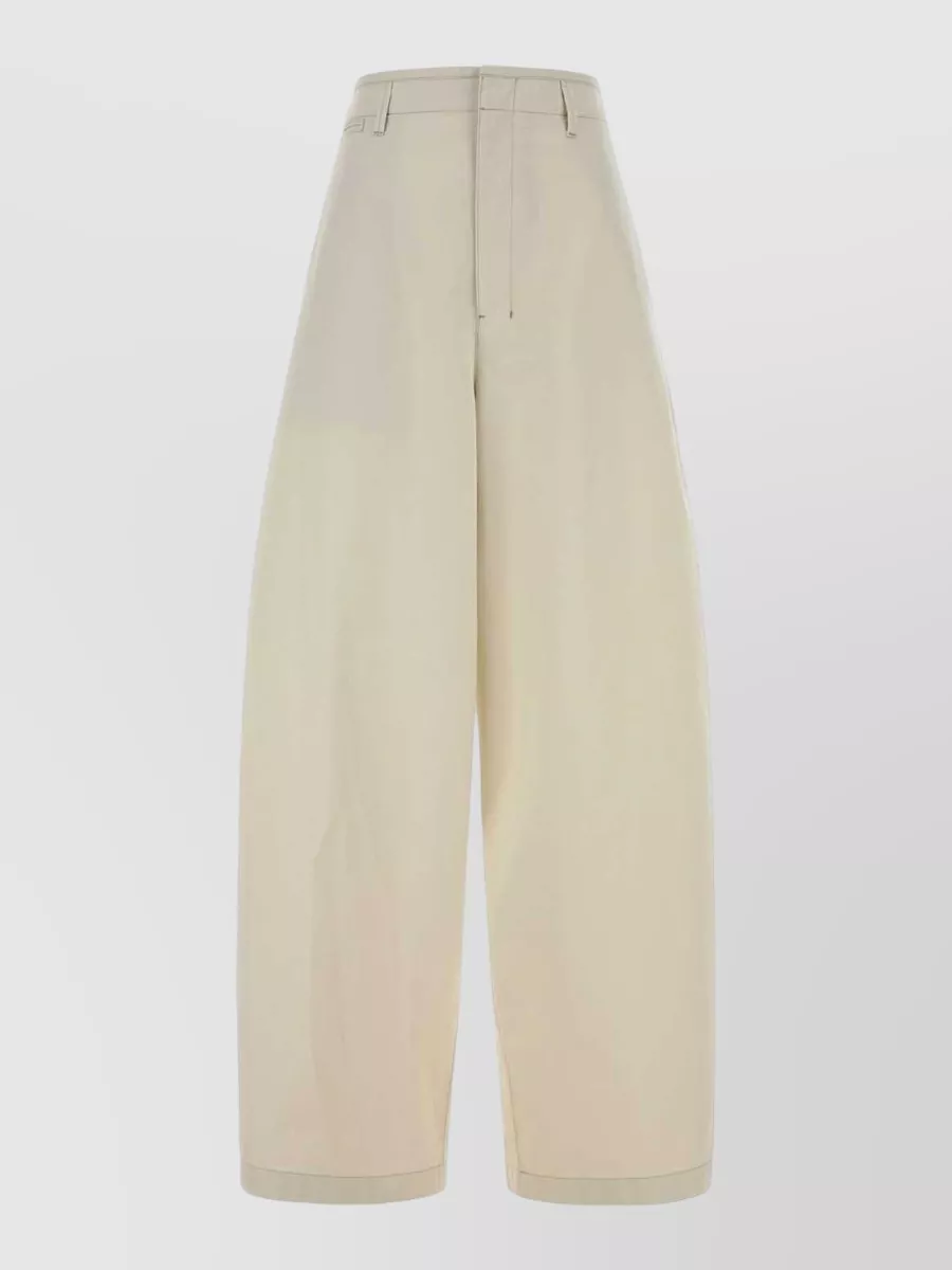 Lemaire Cotton wide-leg trousers — The light-stone high-rise wide leg with its integrated belt mirrors the top’s sculpted waist and minimalist Lemaire language, creating a clean, tonal column that feels polished but relaxed for warm weather.