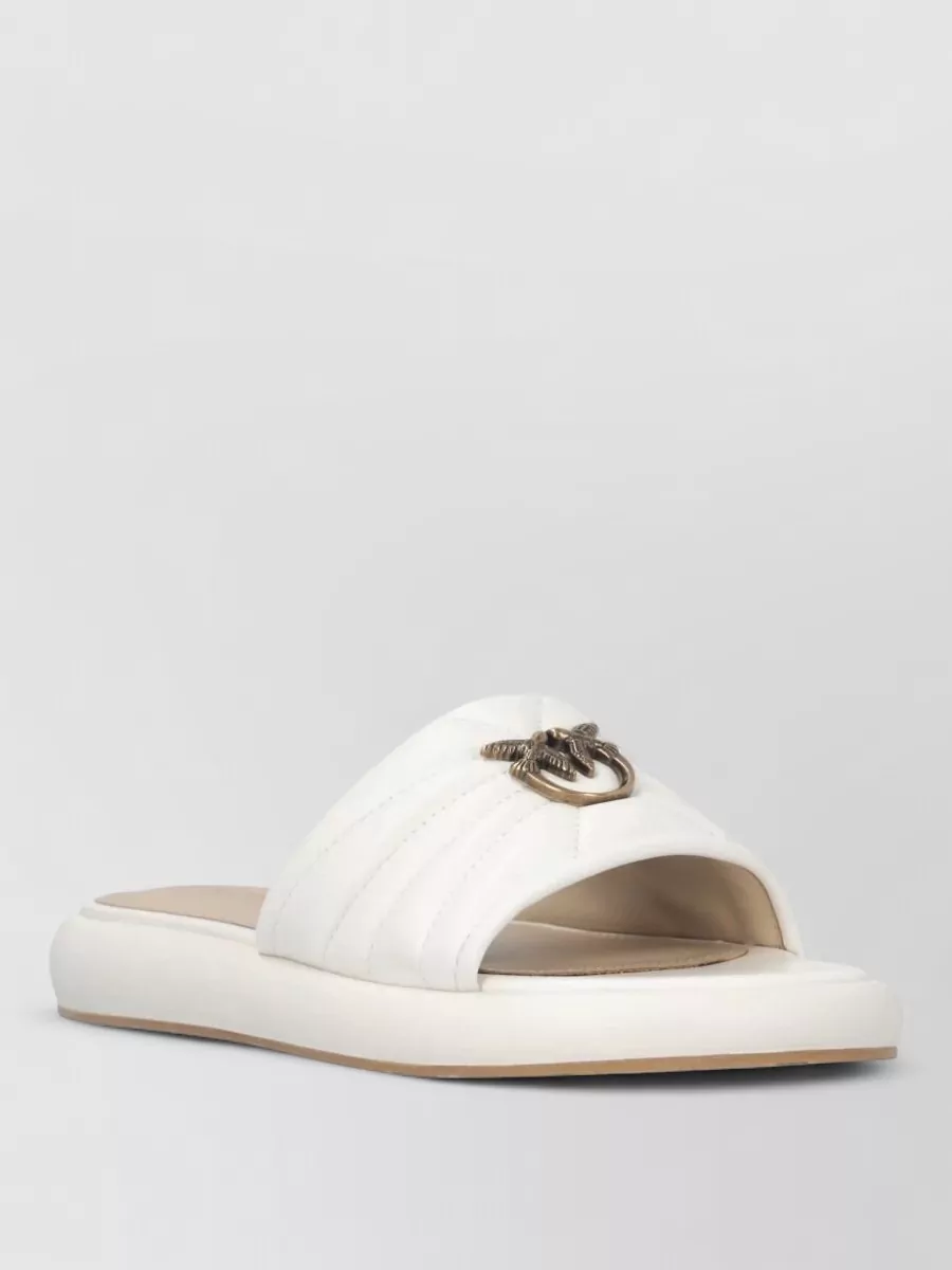 Pinko Leather slides — The all-white chunky platform sneakers echo the minimalist streetwear brief, add visual weight to anchor the straight-leg trouser, and keep the palette light and cohesive for spring and summer.
