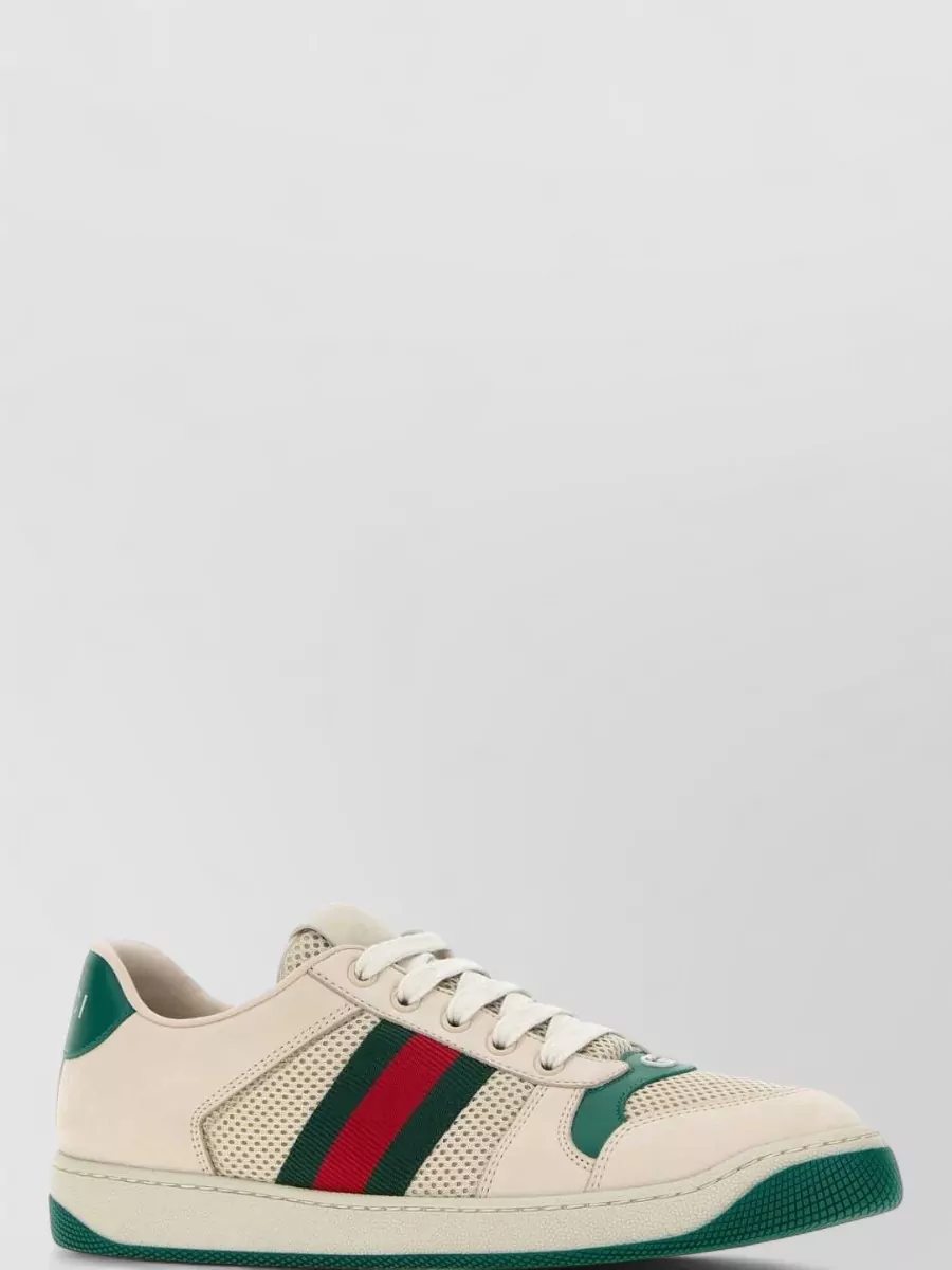 Gucci Suede leather lace-up sneakers — The cream Gucci sneakers with forest green and red stripes echo the knit’s stripe story and reinforce the preppy mood while keeping the outfit relaxed and walkable.
