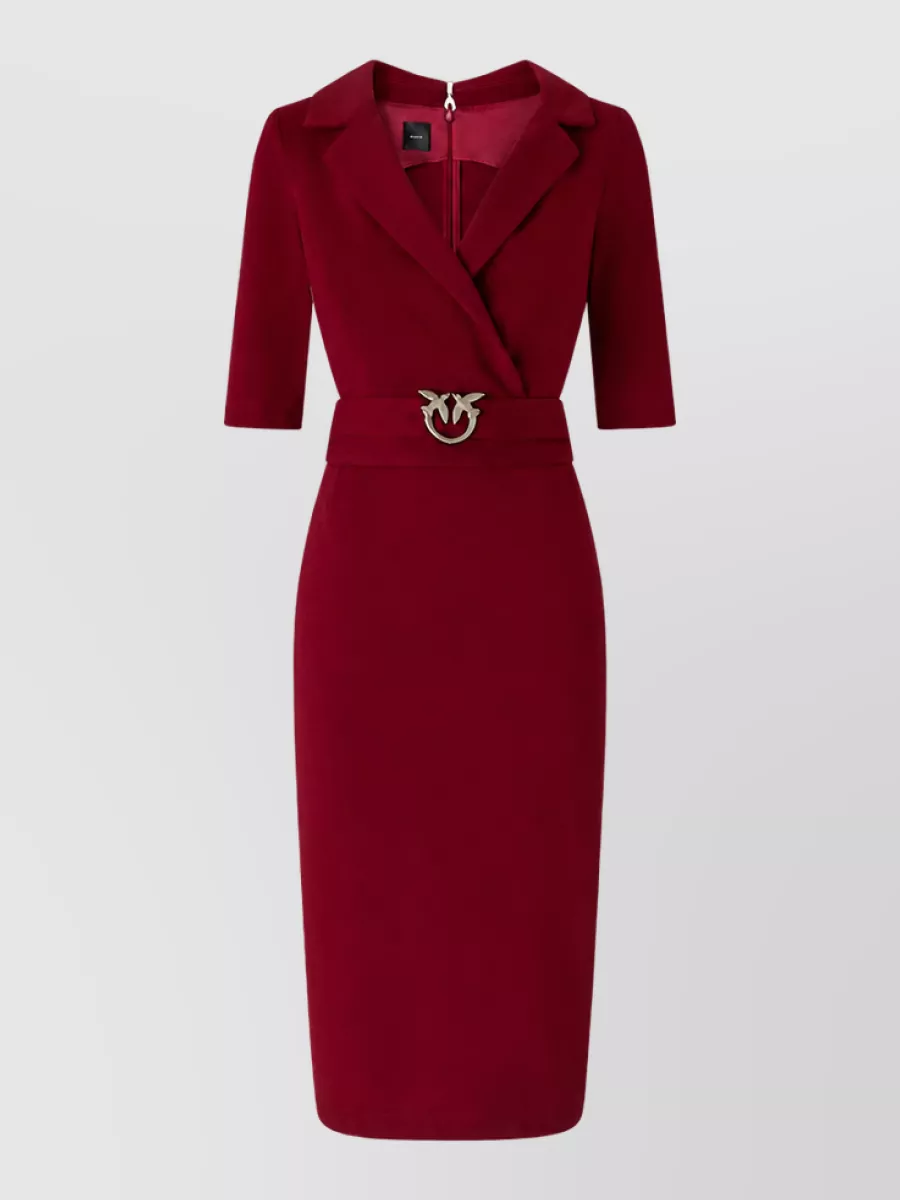 Pinko Evening suit — The deep red tailored midi dress mirrors the coat’s statement red and sharp suiting lines, creating a cohesive, tuxedo-inspired column that reads powerful and evening-ready under the long coat.