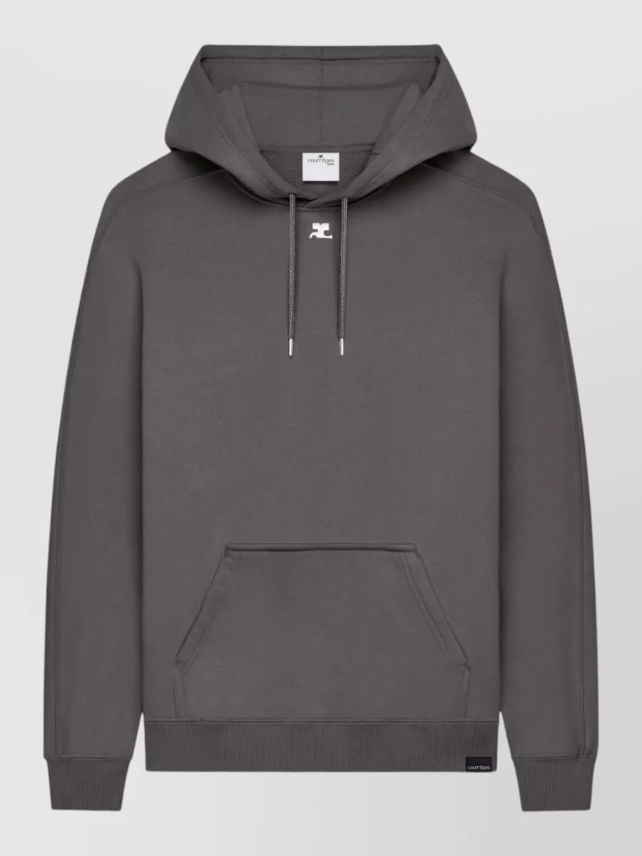 Courrèges Oversized cotton hoodie — The Courrèges charcoal hoodie mirrors the sneaker’s understated, sporty quiet luxury and keeps the palette tight in black, grey and white without loud graphics.