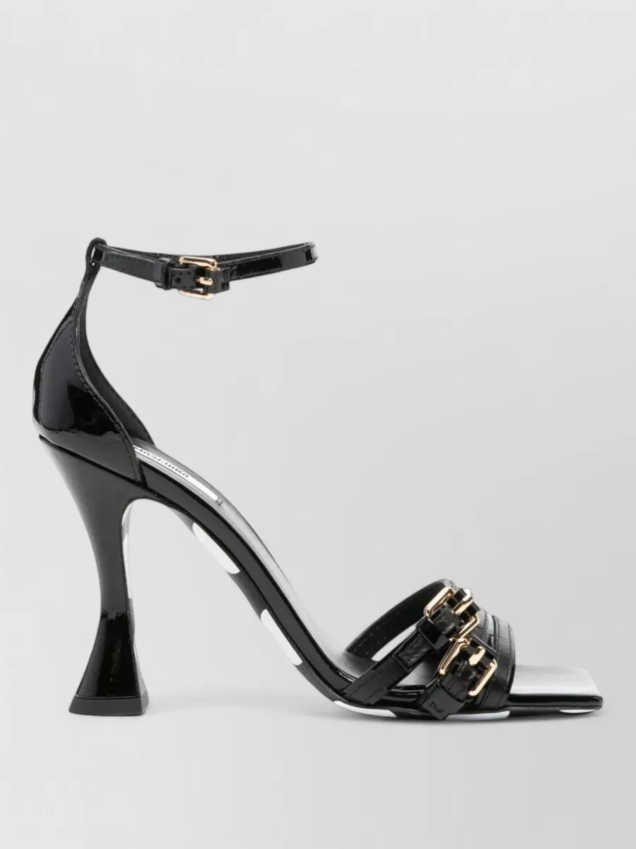 Moschino Leather polka-dot ankle-strap sandals — The Miu Miu black kitten-heel mule is elegant and refined, echoing the skirt’s bows with its own subtle bow detail while keeping the line sleek and comfortable for evenings.