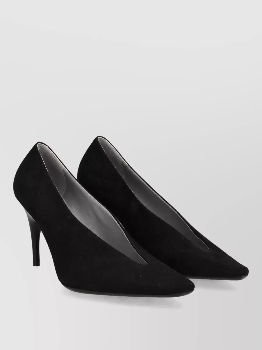 Balenciaga Leather pumps — The black suede pointed stiletto echoes the refined lines of the trouser and keeps the mood polished yet soft, ideal for day-to-dinner tailoring.