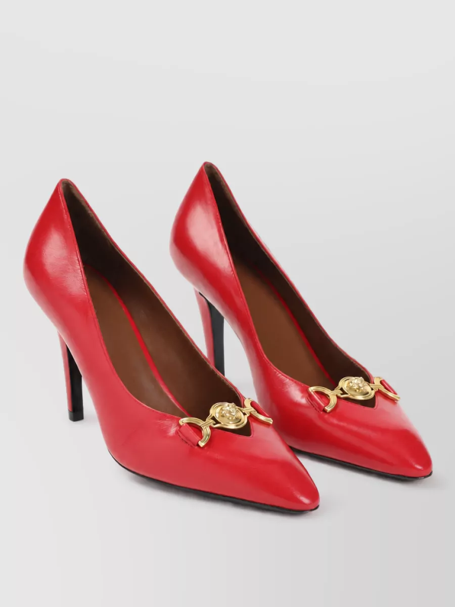 Versace Leather pumps — The vivid red Versace stilettos pick up the red in the Pucci print and match the mini’s dressy level, staying streamlined so the color and top do the talking.