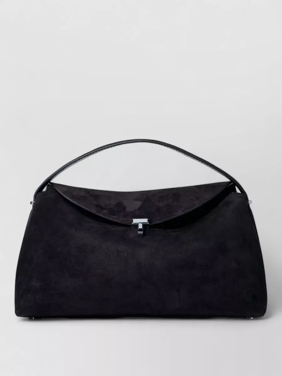 Totême Suede leather top handle tote bag — The black structured curved shoulder bag from Totême keeps the palette tight, the hardware discreet, and the silhouette clean, slotting neatly into a refined, minimalist workwear ensemble.
