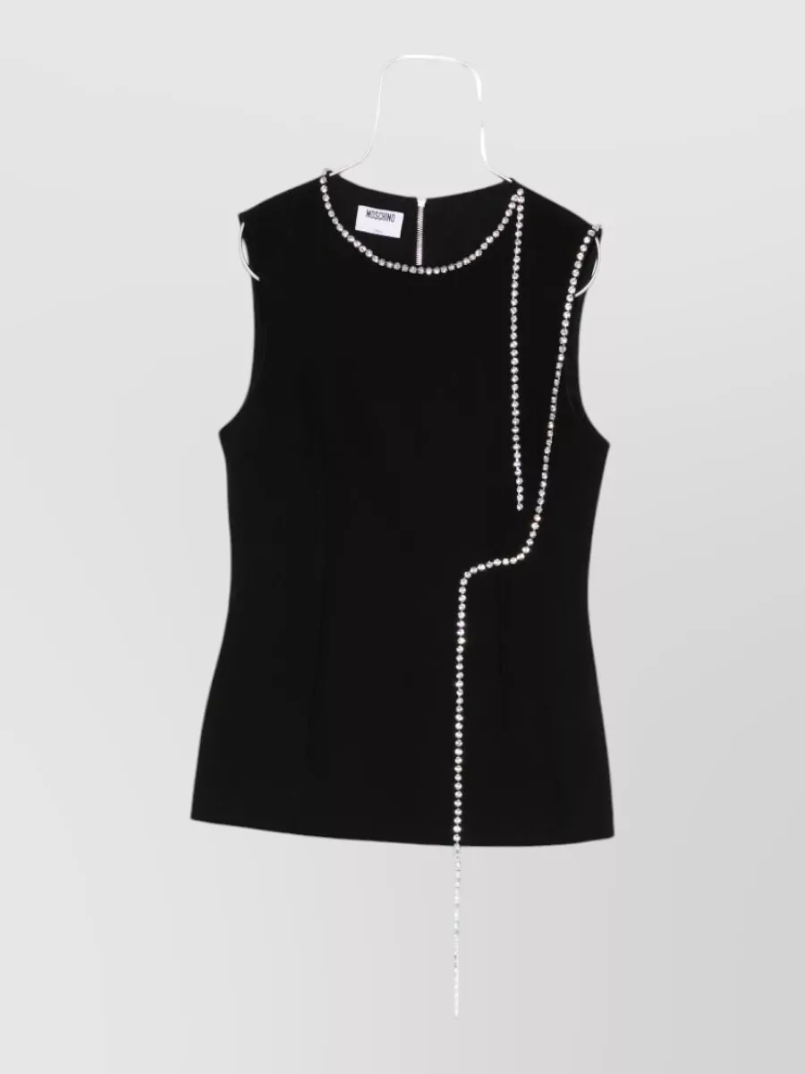 Moschino Blouse — The black crystal-chain shell matches the skirt’s formality and bow-sculptural drama while keeping the palette sharp and monochrome for cocktail dressing.