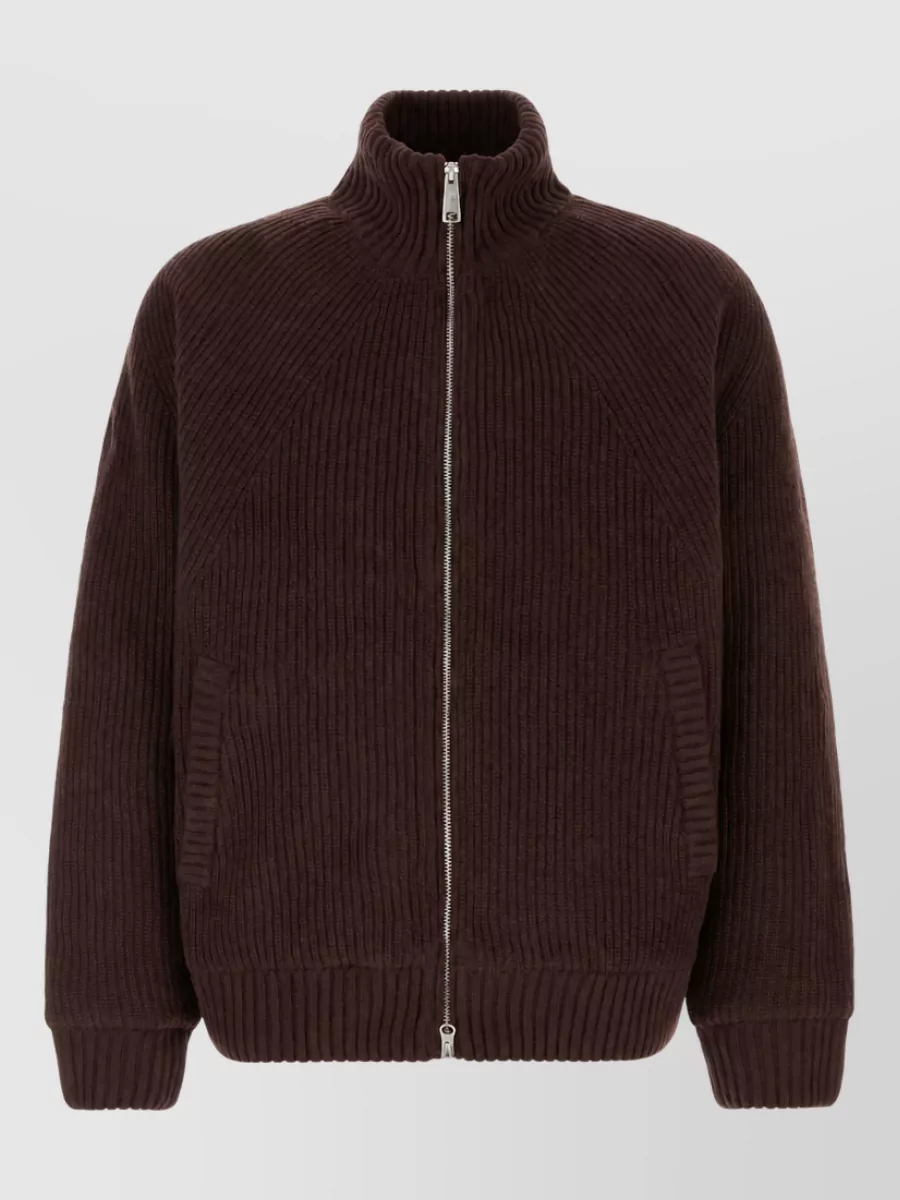 Carhartt Wip Knit sweater jacket — The dark chocolate zip knit mirrors the jacket’s tone for a rich monochrome upper block while the high neck adds interest and warmth without breaking the minimalist workwear mood.