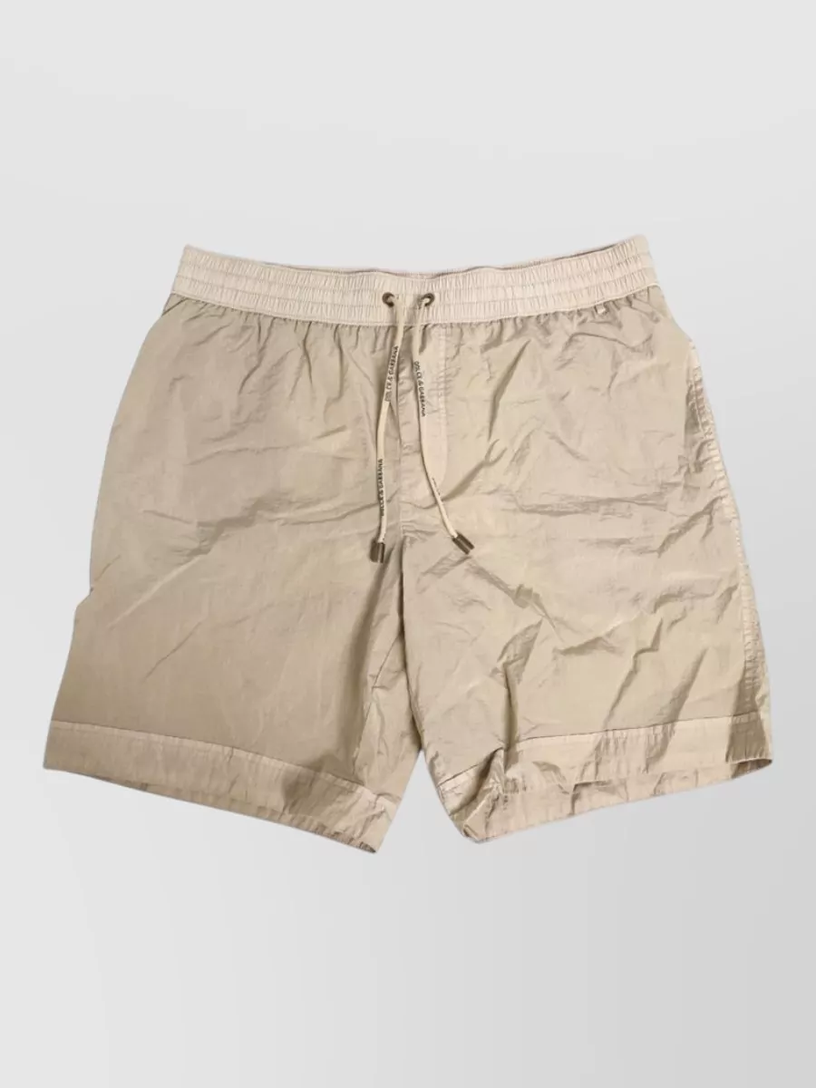 Dolce&Gabbana Nylon swim shorts — The sand shorts keep the palette clean with the sky-blue tee and match its relaxed sport vibe without competing for attention, giving a balanced, quietly graphic summer silhouette.