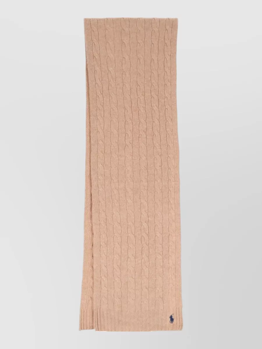 Polo Ralph Lauren Wool cashmere cable knit scarf — The lightweight camel scarf quietly repeats the skirt and bag tones, adding texture and winter practicality without disturbing the minimalist, quiet-luxury palette.