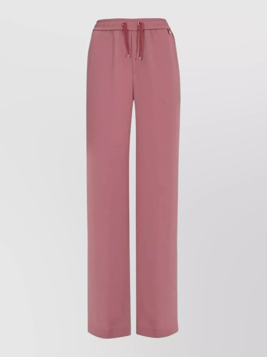 Herno Straight-leg drawstring trousers — The dusty-rose full-length wide leg matches the polo’s tone and relaxed ease, creating a soft monochrome column that feels quietly polished for warm days.