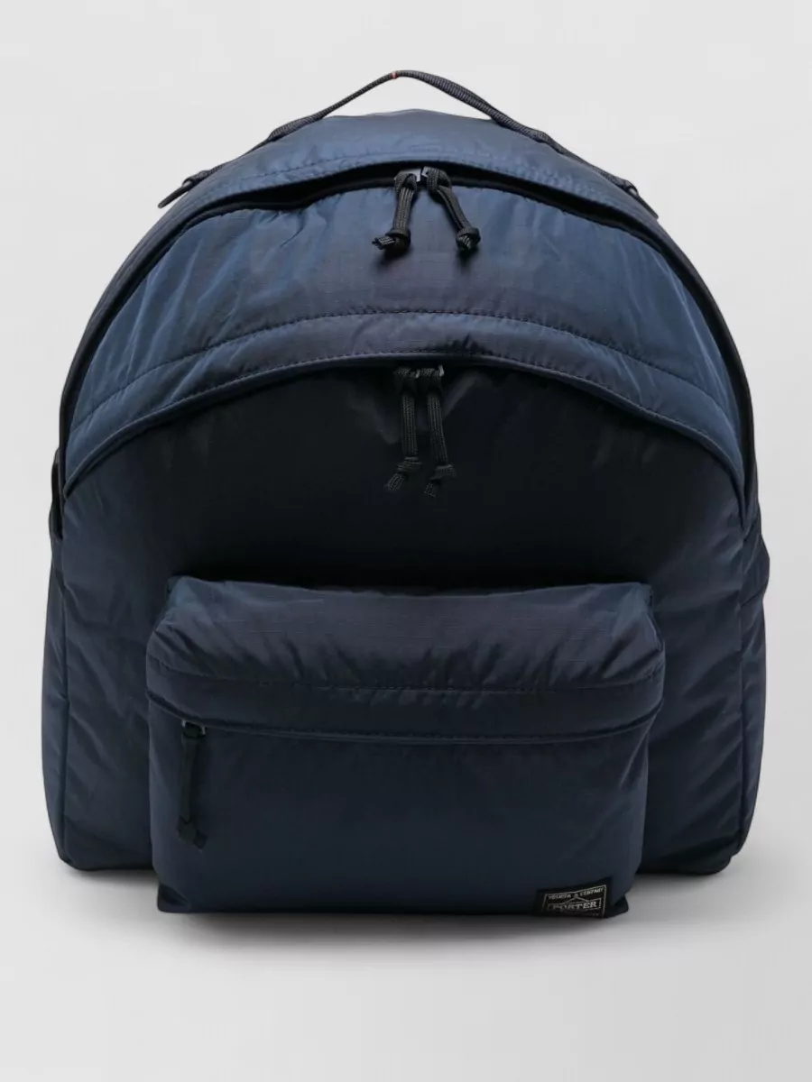Porter Small backpack — The dark chocolate Polo messenger reinforces the campus narrative and formality level, its rich leather grounding the navy and sand palette with a smart collegiate finish.