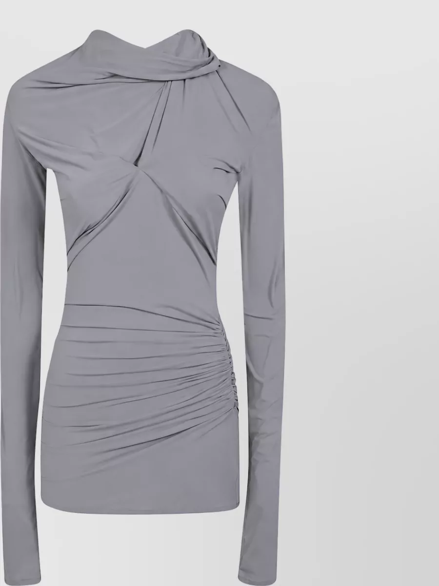 Entire Studios Stretch jersey top — The soft grey ruched long-sleeve mirrors the skirt’s drape and tone, creating a clean monochrome column that feels modern streetwear without tipping too casual or too formal.