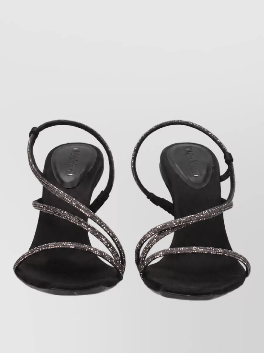 Max Mara Suede pumps — The Dolce&Gabbana mesh sock pumps echo the dress’s sheer polka-dot texture and fitted midi line, creating a continuous, leg-lengthening Y2K-romantic silhouette in pure black.
