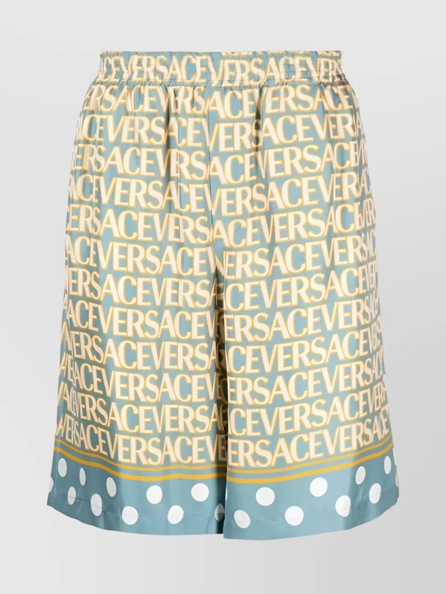 Shop Versace Allover Logo Silk Shorts In Yellow