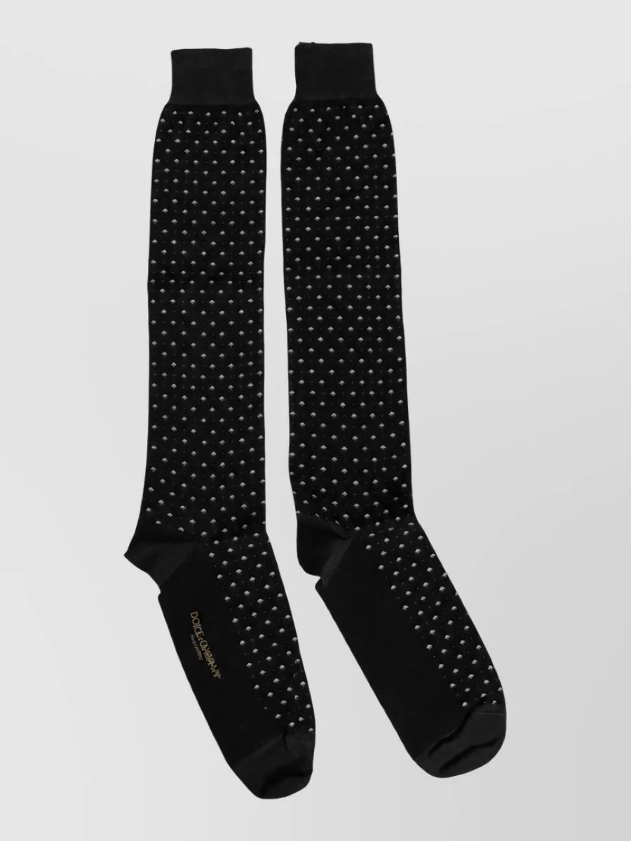 Dolce&Gabbana Polka dot socks — The slim ink‑navy belt in G quietly defines the waist of the pleated trousers and echoes the polo, keeping the line sharp without distracting from the minimal palette.