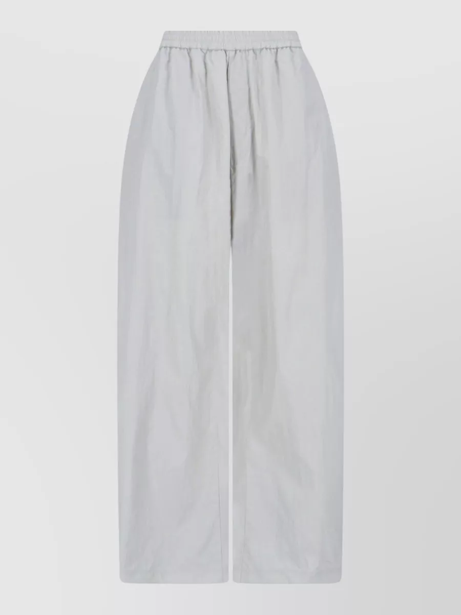 Mm6 Maison Margiela Wide-leg trousers — The inky wide-leg trouser keeps the outfit monochrome and slightly elevated while echoing the hoodie’s cinched, coat-like line with clean volume rather than casual jogger cuffs.