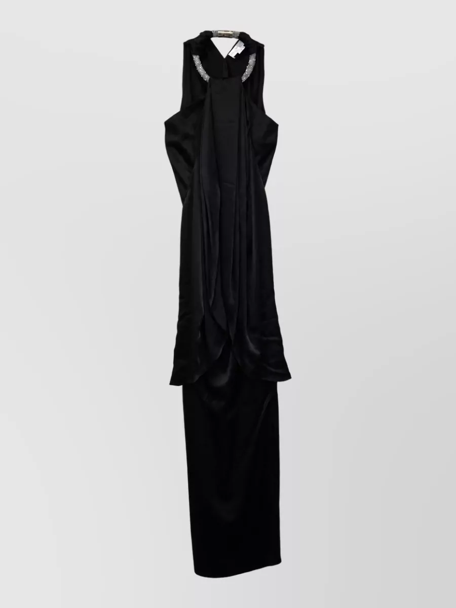 Stella Mccartney Embellished draped maxi dress — The Stella McCartney halter gown mirrors the sandals’ black-and-silver drama and crystal detail, creating a unified, romantic quiet-luxury evening statement without needing additional separates.